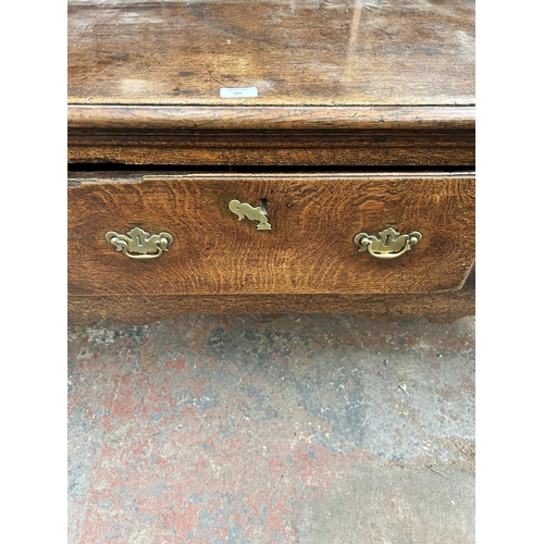 182 - A Georgian oak dresser base with three drawers and cabriole supports