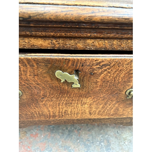 182 - A Georgian oak dresser base with three drawers and cabriole supports