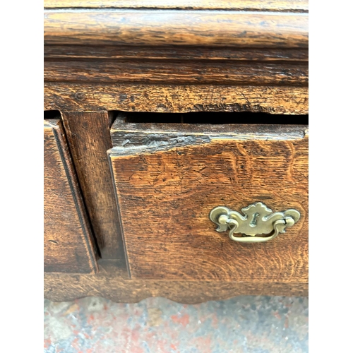 182 - A Georgian oak dresser base with three drawers and cabriole supports