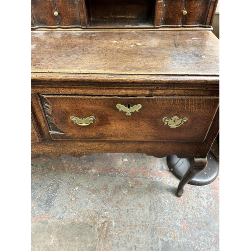 182 - A Georgian oak dresser base with three drawers and cabriole supports