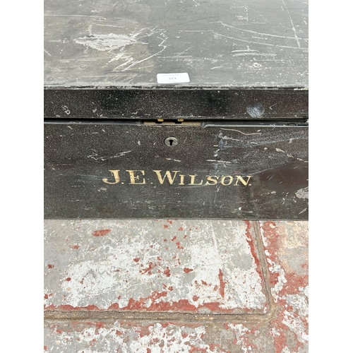 183 - An early 20th century black metal travel trunk