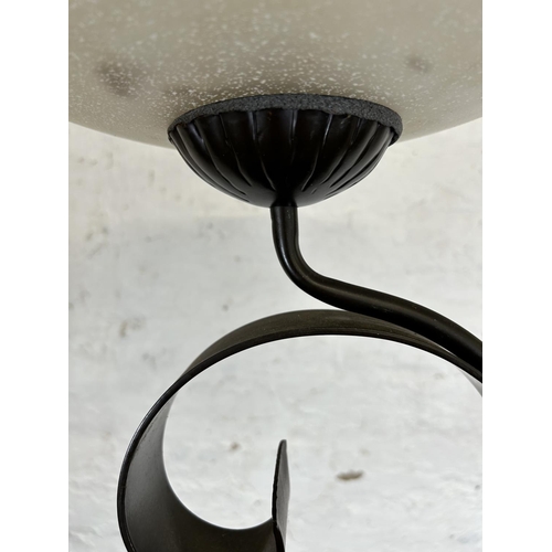 184 - A modern brown metal standard lamp with glass shade - approx. 179cm high