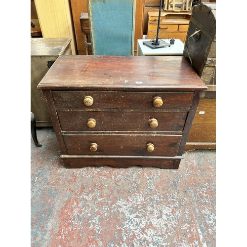 186 - A Victorian stained pine chest of three drawers