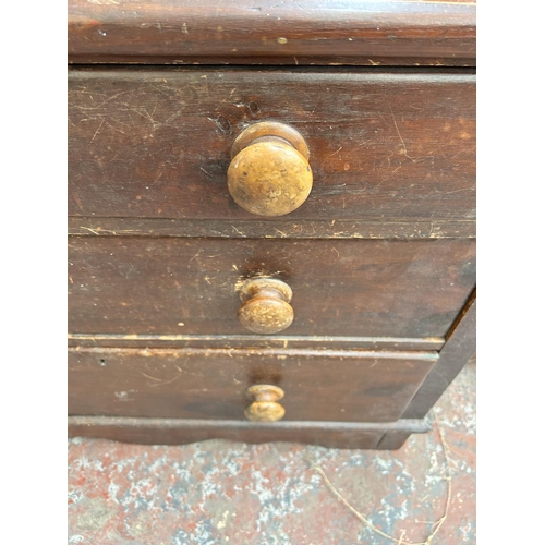 186 - A Victorian stained pine chest of three drawers