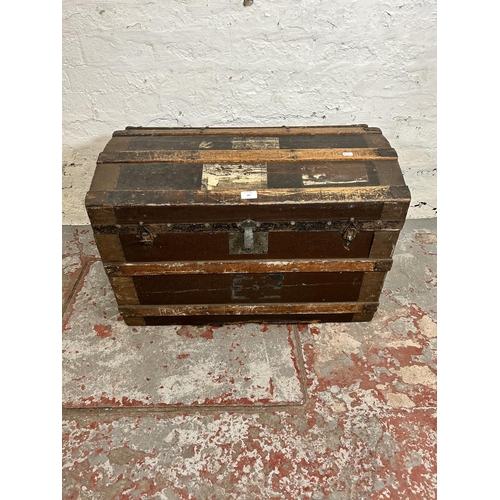 187 - An early 20th century wooden banded and canvas dome top travel trunk