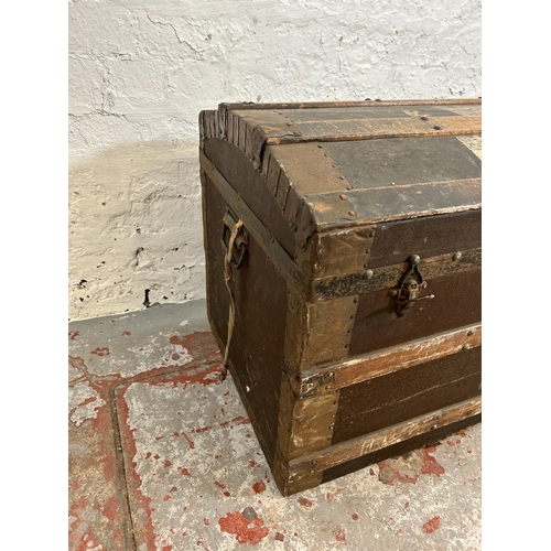 187 - An early 20th century wooden banded and canvas dome top travel trunk