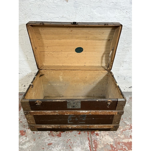 187 - An early 20th century wooden banded and canvas dome top travel trunk