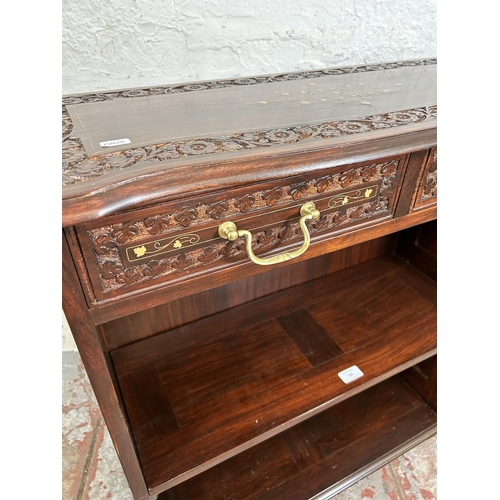 189 - An Indian brass inlaid and carved hardwood two tier open bookcase with two drawers