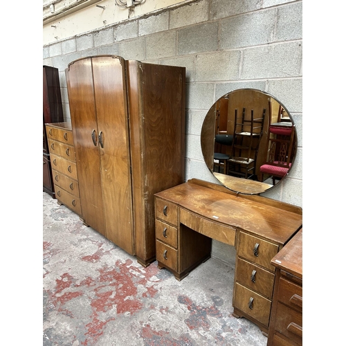 19 - An Art Deco style walnut three piece bedroom suite comprising dressing table, double wardrobe and ch... 