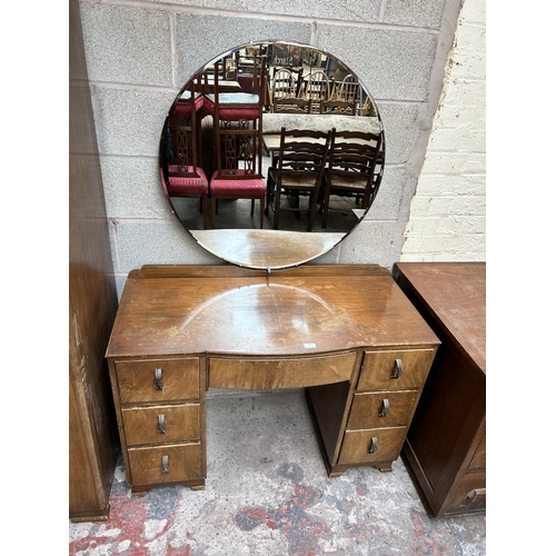 19 - An Art Deco style walnut three piece bedroom suite comprising dressing table, double wardrobe and ch... 