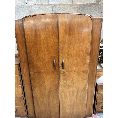 19 - An Art Deco style walnut three piece bedroom suite comprising dressing table, double wardrobe and ch... 