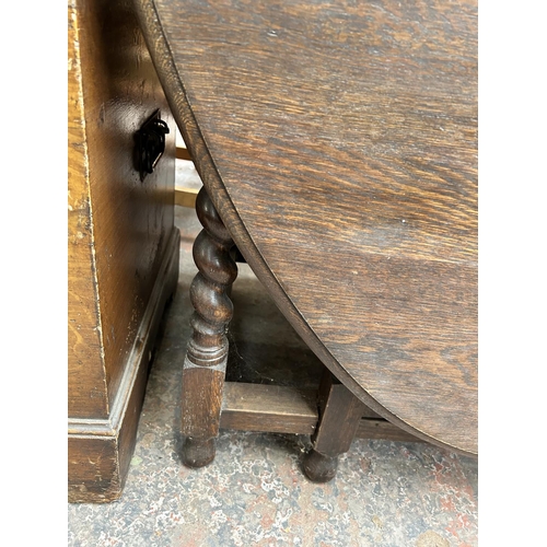 190 - An early 20th century oak drop leaf gate leg dining table on barley twist supports