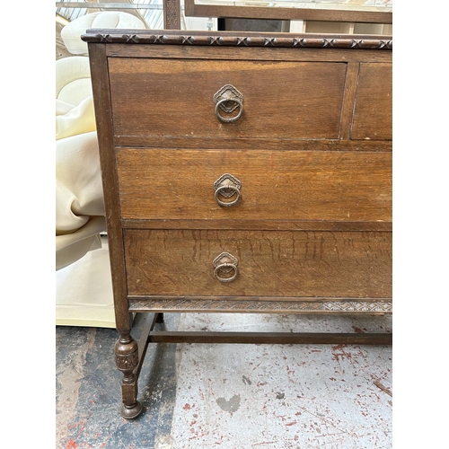 196 - An early 20th century oak dressing chest with two short drawers, two long drawers and upper bevelled... 