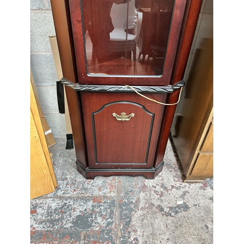 20 - A late 20th century mahogany effect free standing corner cabinet