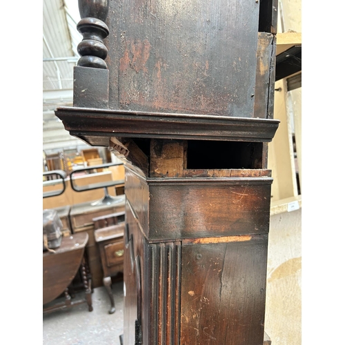 207 - A George III inlaid mahogany cased grandfather clock with pendulum and two weights