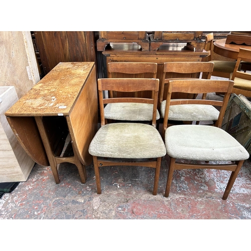 209 - A mid 20th century teak drop leaf gate leg dining table and four matching dining chairs