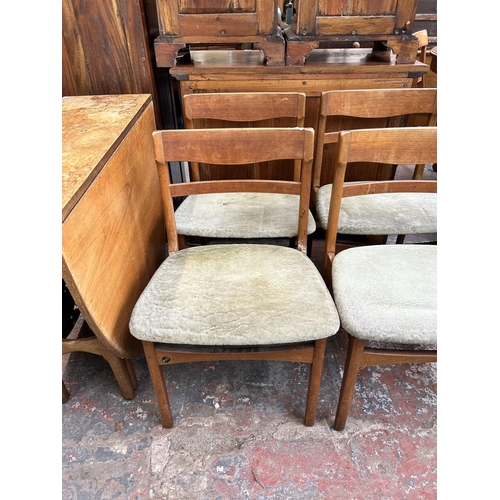 209 - A mid 20th century teak drop leaf gate leg dining table and four matching dining chairs