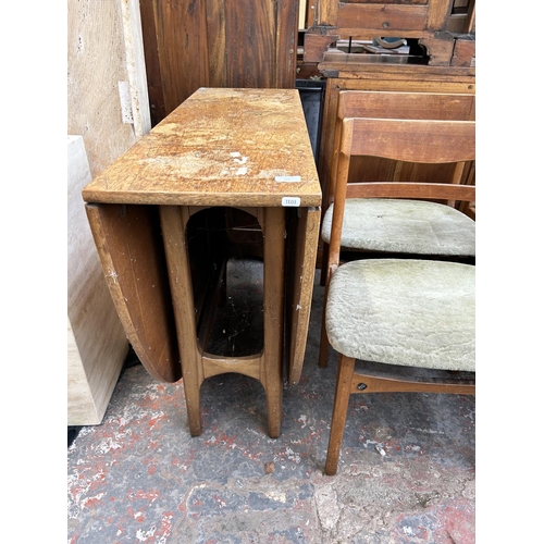 209 - A mid 20th century teak drop leaf gate leg dining table and four matching dining chairs