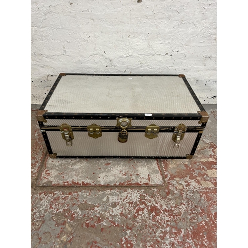 215 - A mid 20th century silver and black painted travel trunk