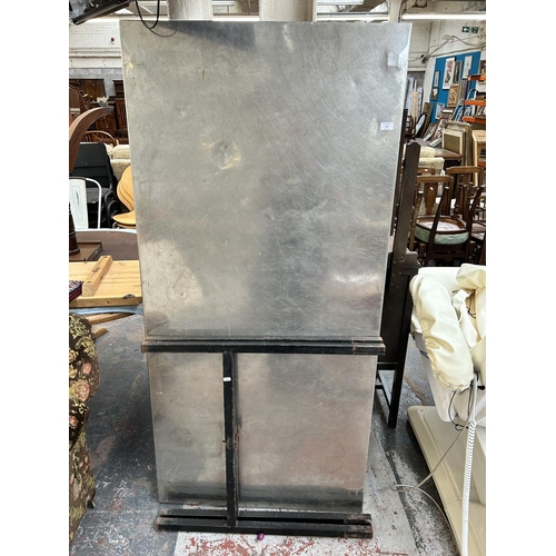 219 - A steel and black metal kitchen work table - approx. 177cm long x 84xm wide