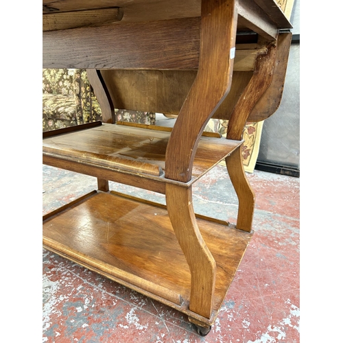 221 - A 1960s Tenax Manchester walnut drop leaf three tier tea trolley