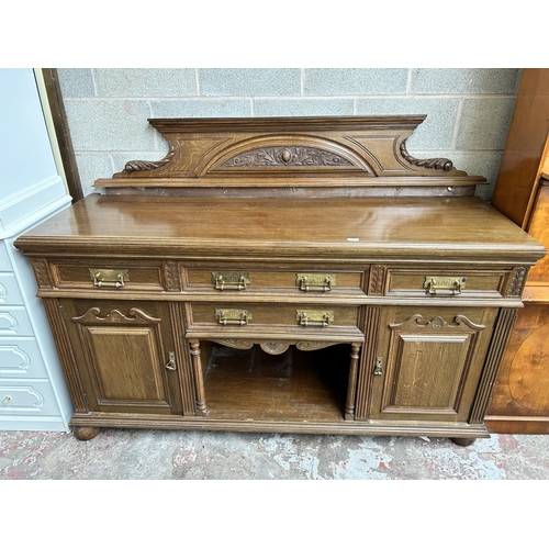 27 - A late 19th/early 20th century carved oak sideboard with galleried back, four drawers and two cupboa... 