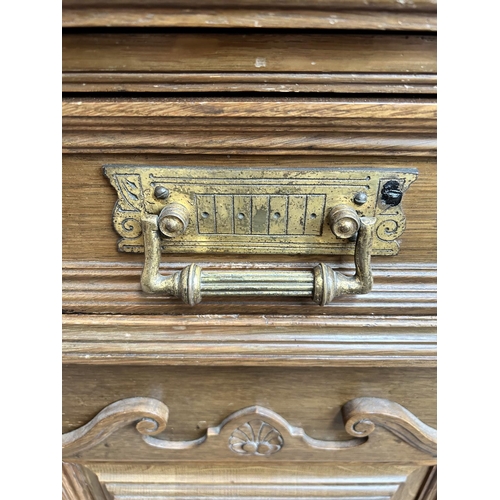 27 - A late 19th/early 20th century carved oak sideboard with galleried back, four drawers and two cupboa... 