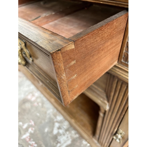 27 - A late 19th/early 20th century carved oak sideboard with galleried back, four drawers and two cupboa... 