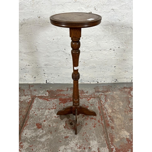 37 - A mid 20th century oak circular top jardinière stand - approx. 85cm high