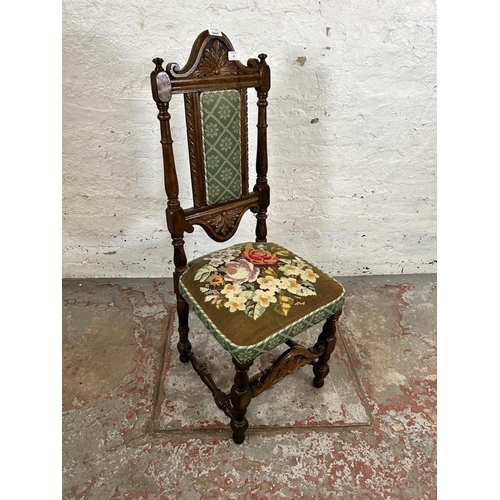 39 - An early 20th century carved oak and tapestry upholstered hall chair