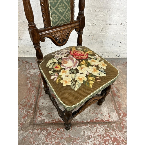 39 - An early 20th century carved oak and tapestry upholstered hall chair