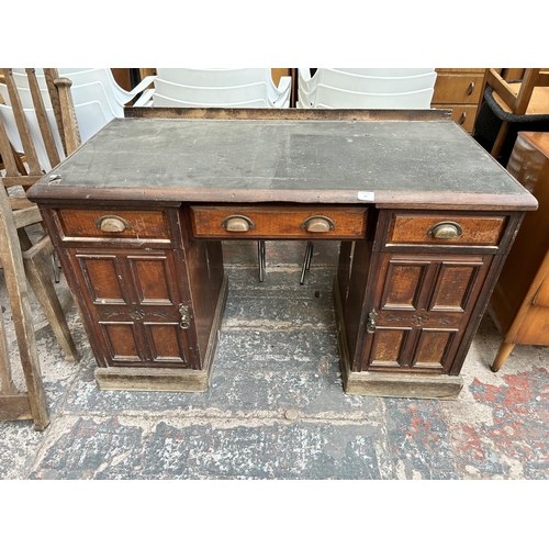 43 - A Victorian mahogany pedestal desk with black leather writing surface, three drawers and two cupboar... 