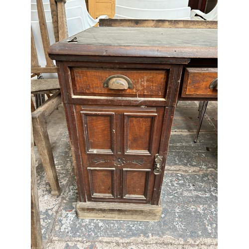 43 - A Victorian mahogany pedestal desk with black leather writing surface, three drawers and two cupboar... 