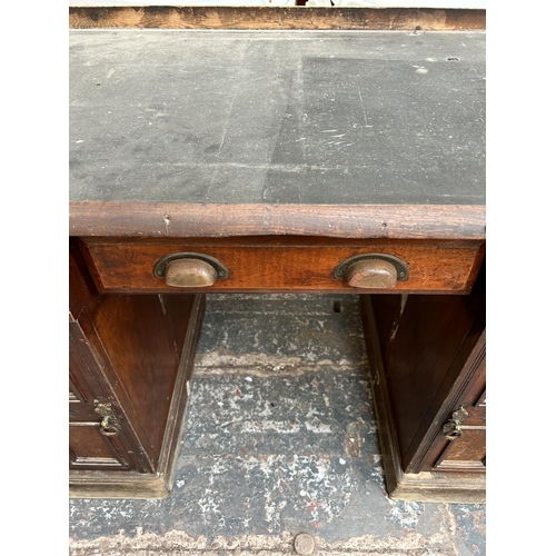 43 - A Victorian mahogany pedestal desk with black leather writing surface, three drawers and two cupboar... 