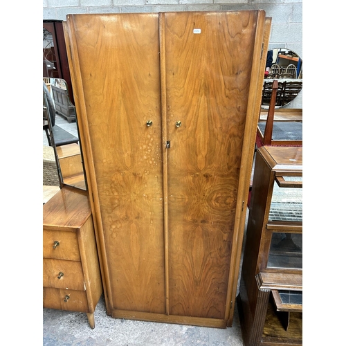 44 - A mid 20th century walnut two piece bedroom suite comprising double wardrobe and dressing table