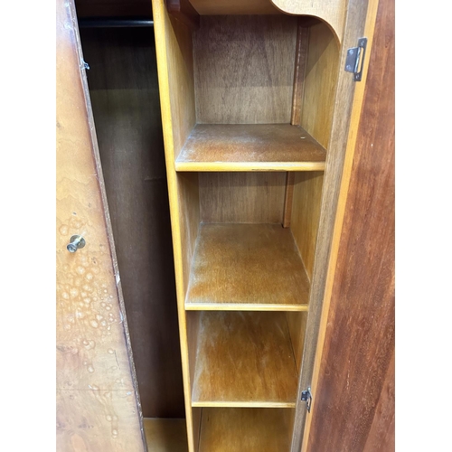 44 - A mid 20th century walnut two piece bedroom suite comprising double wardrobe and dressing table