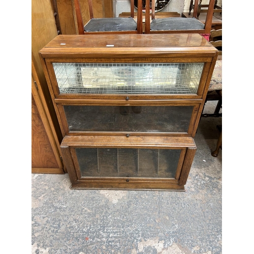 45 - A Globe Wernicke style walnut three section bookcase - approx. 107cm high x 90cm wide x 38cm deep