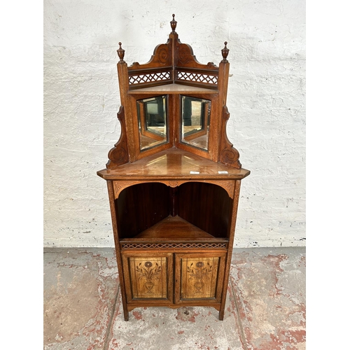 50 - An Edwardian carved mahogany free standing corner cabinet with two upper bevelled edge mirrors, two ... 