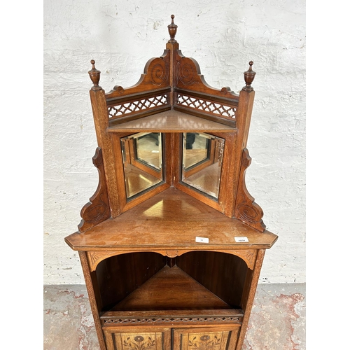 50 - An Edwardian carved mahogany free standing corner cabinet with two upper bevelled edge mirrors, two ... 