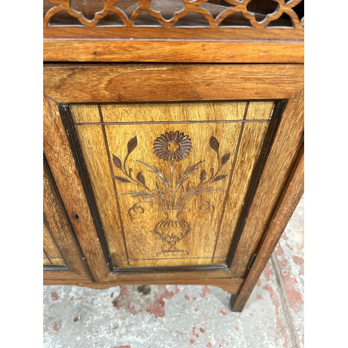 50 - An Edwardian carved mahogany free standing corner cabinet with two upper bevelled edge mirrors, two ... 