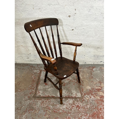 54 - A Victorian elm and beech spindle back farmhouse armchair