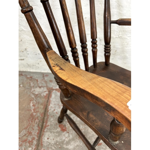 54 - A Victorian elm and beech spindle back farmhouse armchair