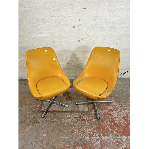 59 - A pair of mid 20th century yellow vinyl and chrome plated swivel dining chairs