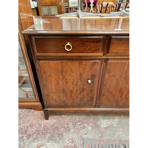 66 - A Stag Minstrel mahogany sideboard with three drawers and three cupboard doors