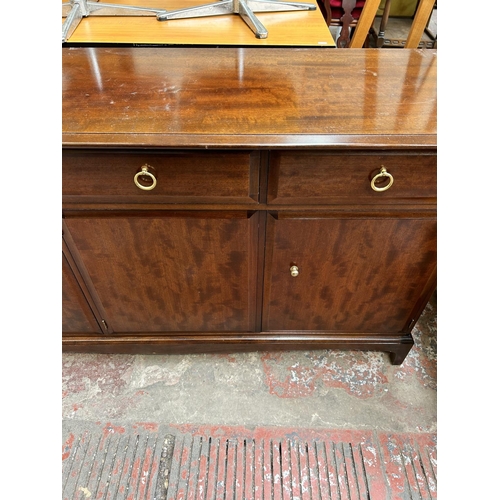 66 - A Stag Minstrel mahogany sideboard with three drawers and three cupboard doors