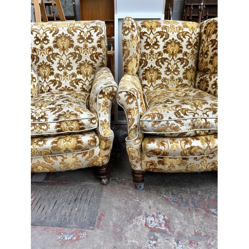 68 - A pair of early 20th century floral upholstered his and hers armchairs on mahogany turned supports a... 