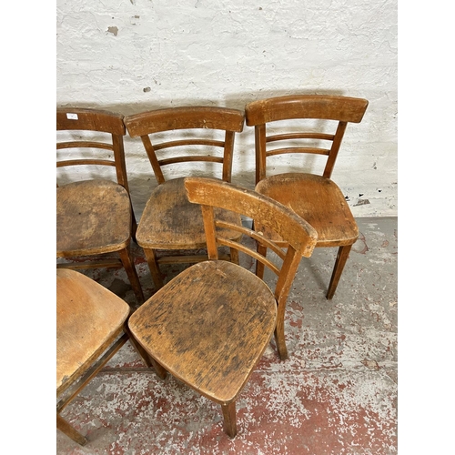 77 - A set of six 1950s beech dining chairs - more than one exhibit woodworm holes