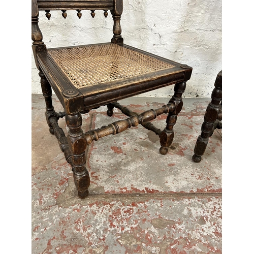 78 - A pair of Victorian carved oak and rattan occasional chairs, both monogrammed 'JHEH' to underside