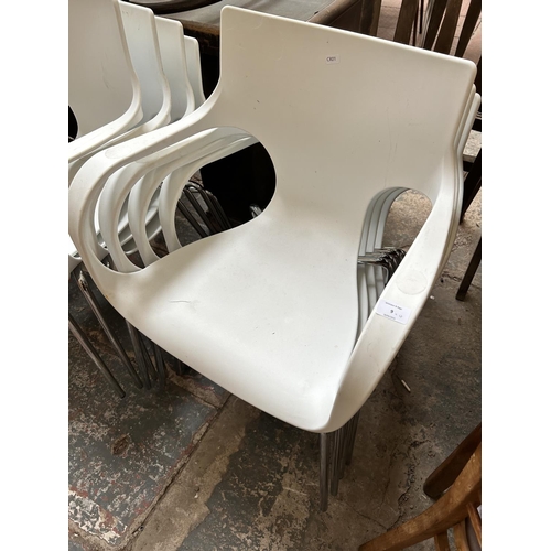 9 - Thirteen white plastic and tubular metal stacking armchairs