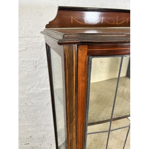 90 - An Edwardian inlaid mahogany display cabinet with single leaded glass door and tapering supports